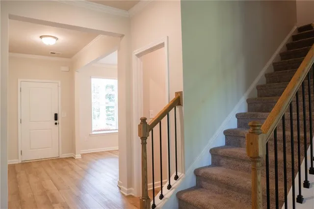 a view of entryway and hall with wooden floor