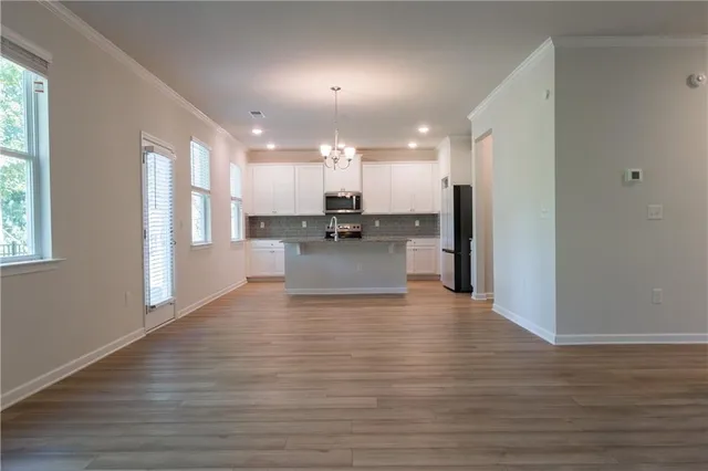 a view of a kitchen with cabinets and wooden floor