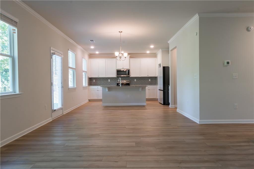 4545 Ajo Walk Atlanta, GA 30331 - Photo 10 of 28 a view of a kitchen with cabinets and wooden floor