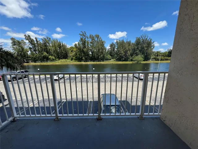 a view of swimming pool with lake and green space