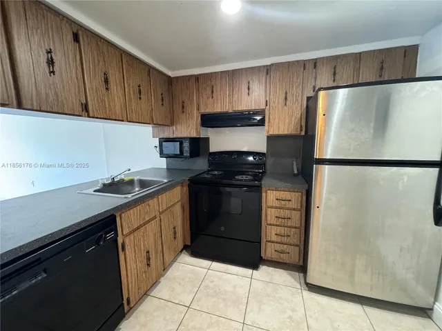 a kitchen with a refrigerator and a sink