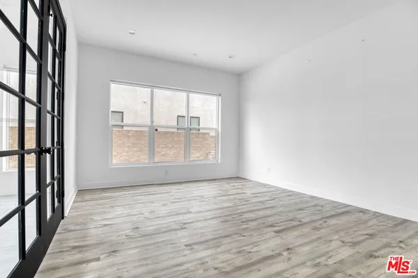 a kitchen with stainless steel appliances granite countertop a sink a stove and white cabinets