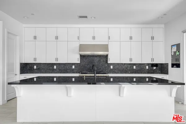 a kitchen with stainless steel appliances a sink a stove and a refrigerator