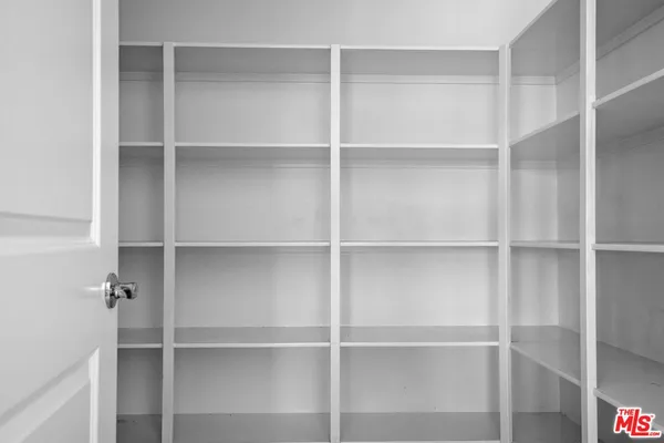 a view of an empty room with a fireplace and a window