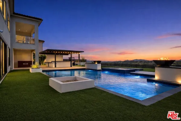 a view of a swimming pool with a table and chairs