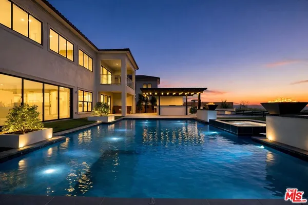 a view of a swimming pool with a lounge chair