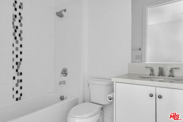 a utility room with cabinets washer and dryer