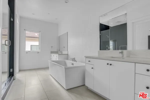 a room with a sink and a refrigerator