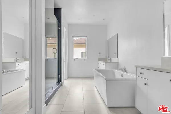a bathroom with a tub shower and sink