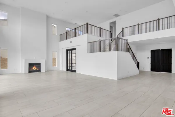 a view of a livingroom with an entryway and fireplace