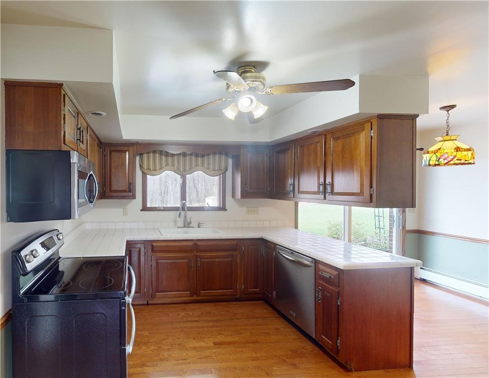 420 Sawmill Run Road Butler, PA 16001 - Photo 12 of 46 a kitchen with a sink appliances and cabinets
