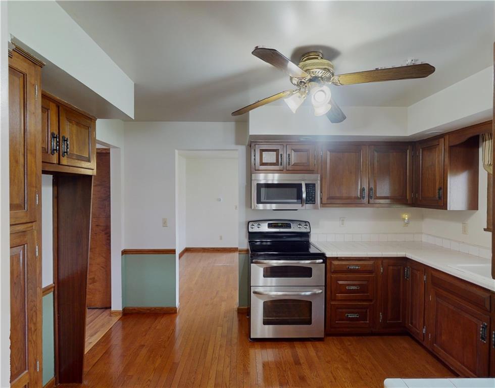 420 Sawmill Run Road Butler, PA 16001 - Photo 13 of 46 a kitchen with stainless steel appliances a stove sink and microwave
