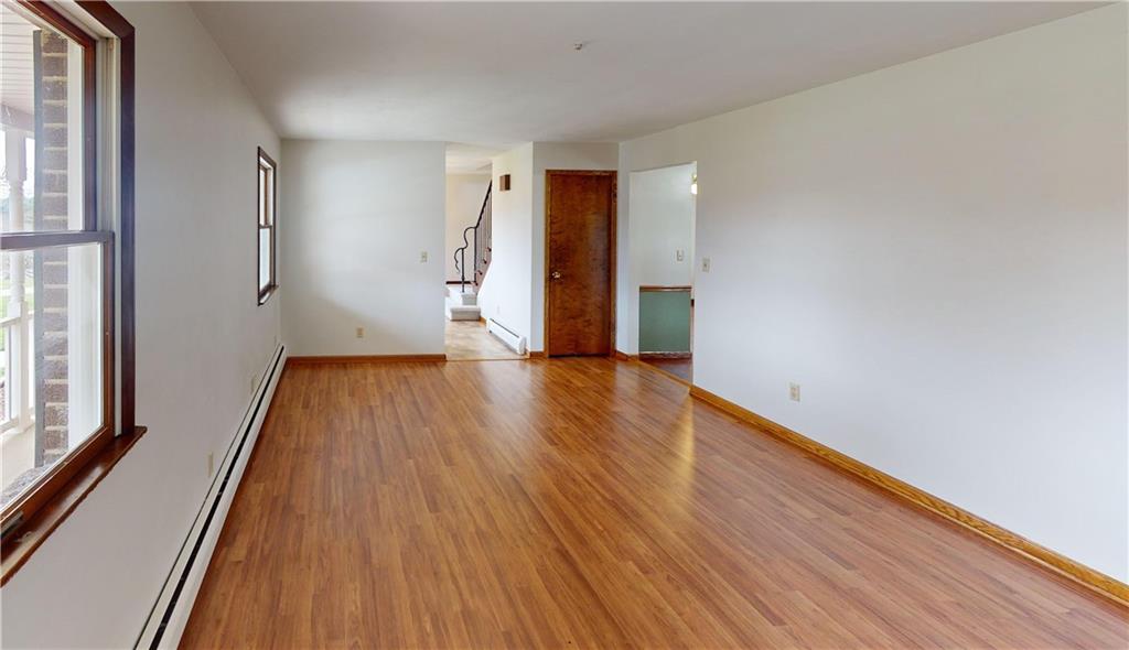 420 Sawmill Run Road Butler, PA 16001 - Photo 17 of 46 a view of an empty room with wooden floor and a window