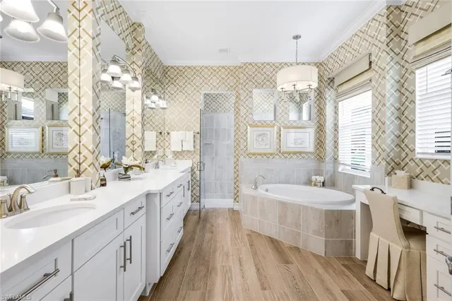 a spacious bedroom with a bed dresser and a large mirror