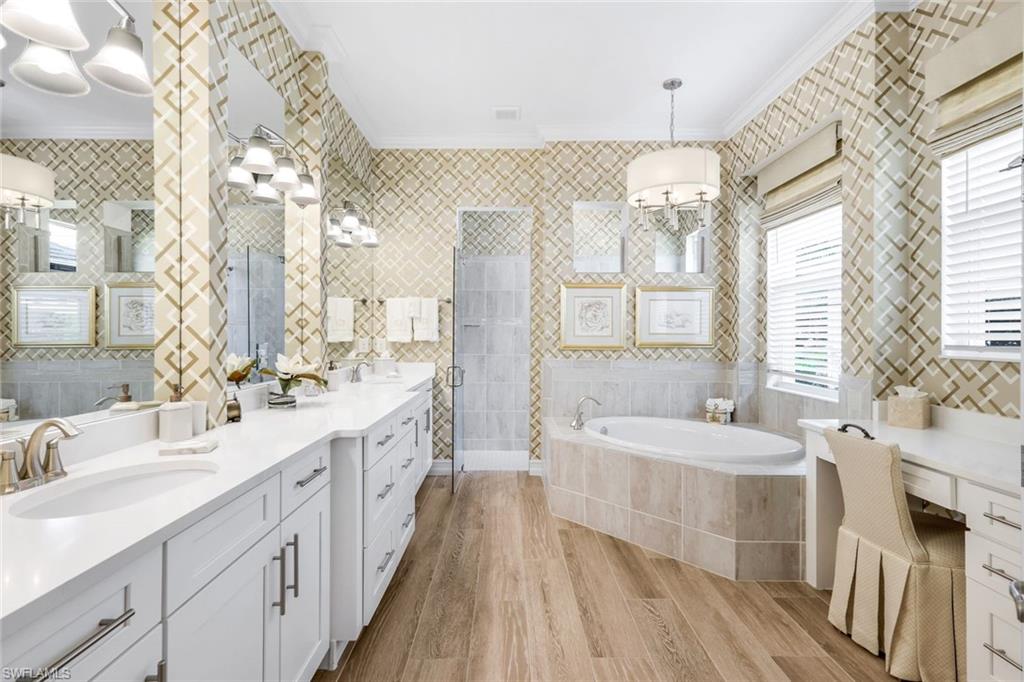 14630 Blue Bay Circle Fort Myers, FL 33913 - Photo 15 of 49 a spacious bathroom with double vanity a mirror a vanity and a bathtub