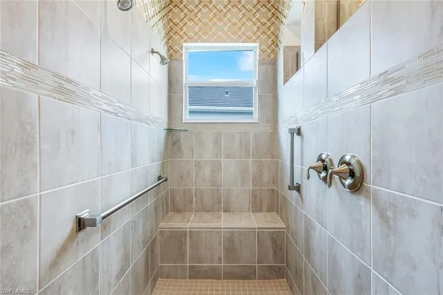 a spacious bathroom with double vanity sinks a large mirror and a bathtub