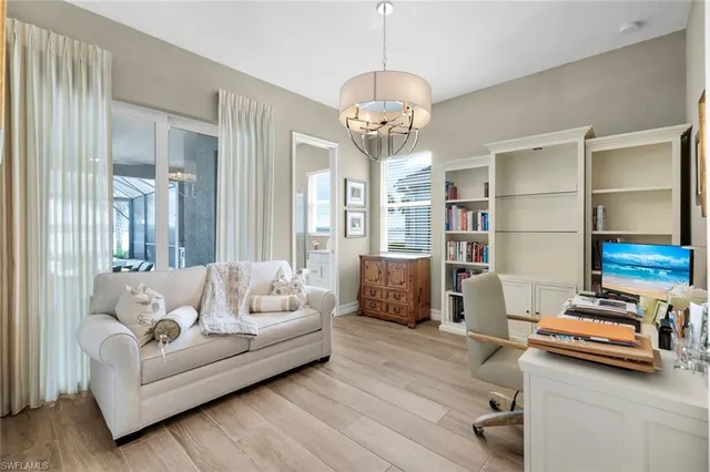 a living room with furniture and a chandelier