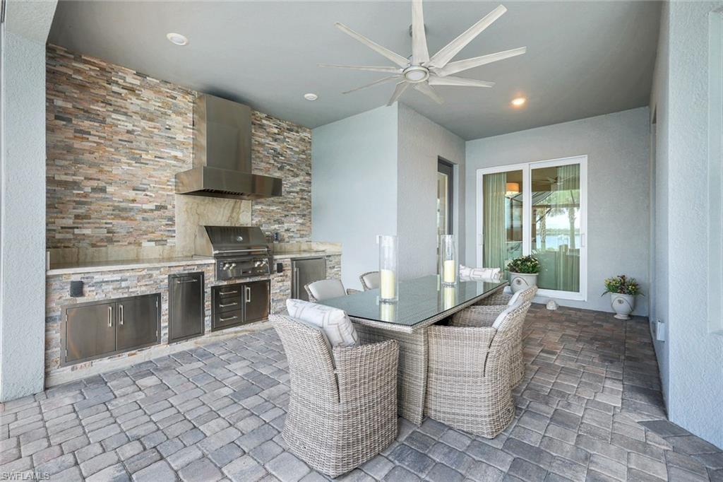 14630 Blue Bay Circle Fort Myers, FL 33913 - Photo 28 of 49 a kitchen with stainless steel appliances kitchen island granite countertop a sink and a stove