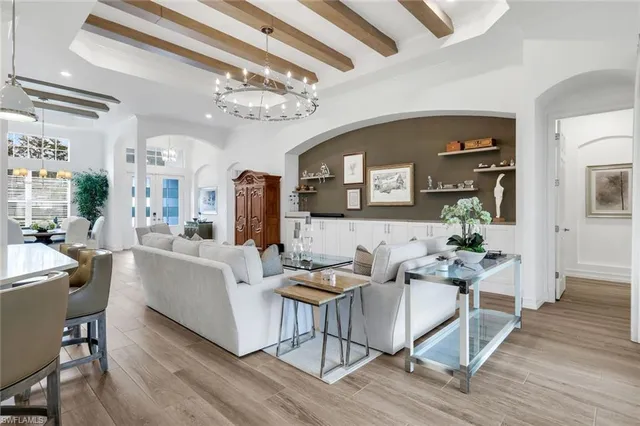 a living room with furniture and a chandelier