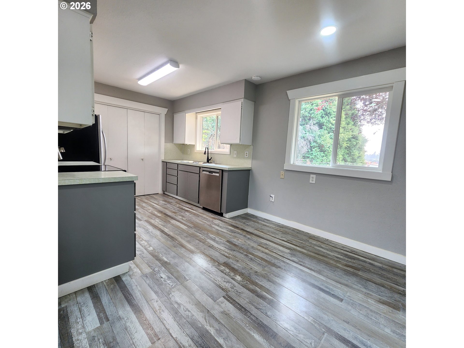 54047 West Lane Road Scappoose, OR 97056 - Photo 4 of 44 a view of a kitchen with wooden floor and electronic appliances