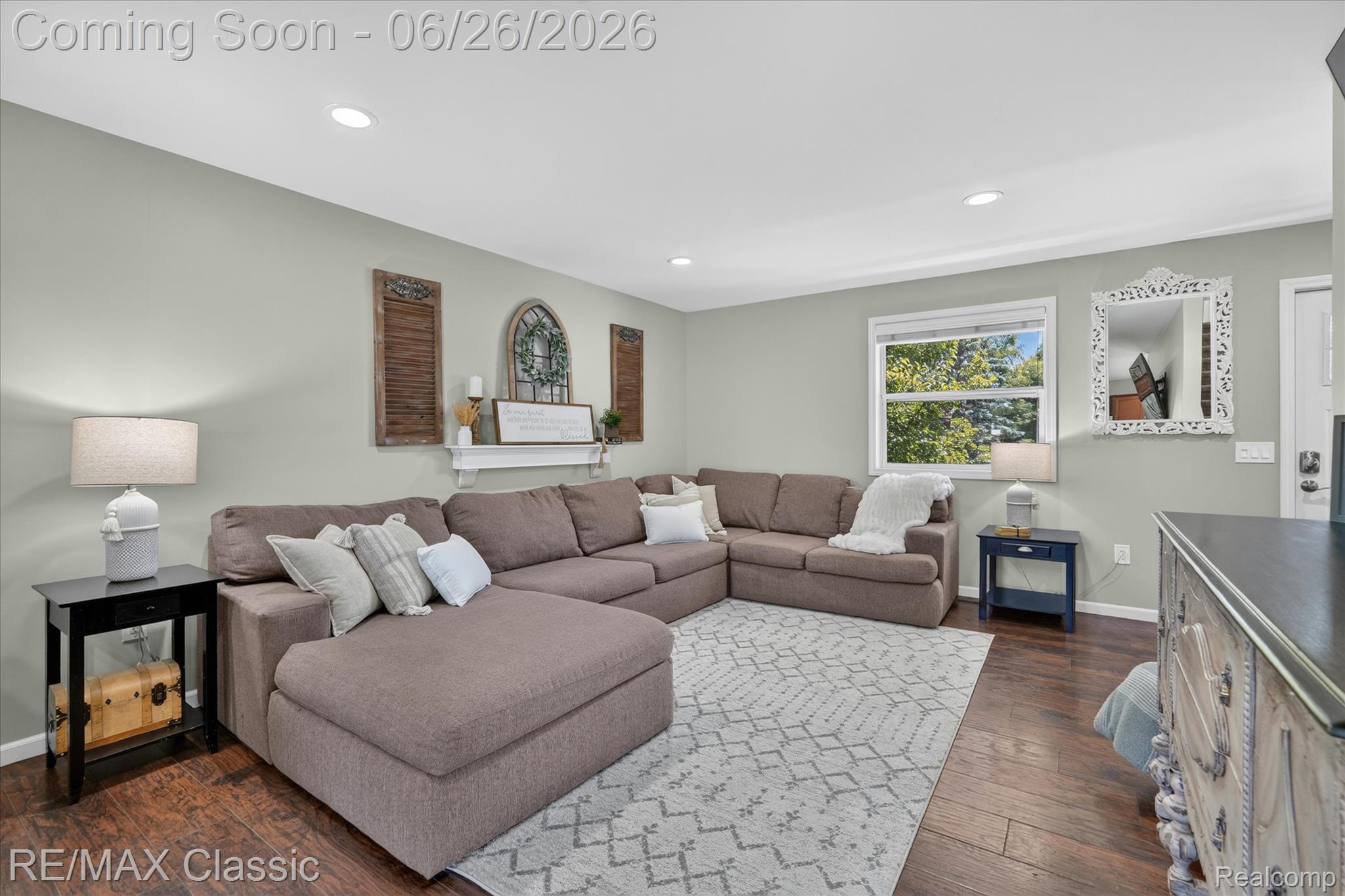 3205 North Milford Road Highland, MI 48357 - Photo 6 of 53 Spacious living area featuring wood-finish flooring, recessed lighting, and a window with outdoor landscaping