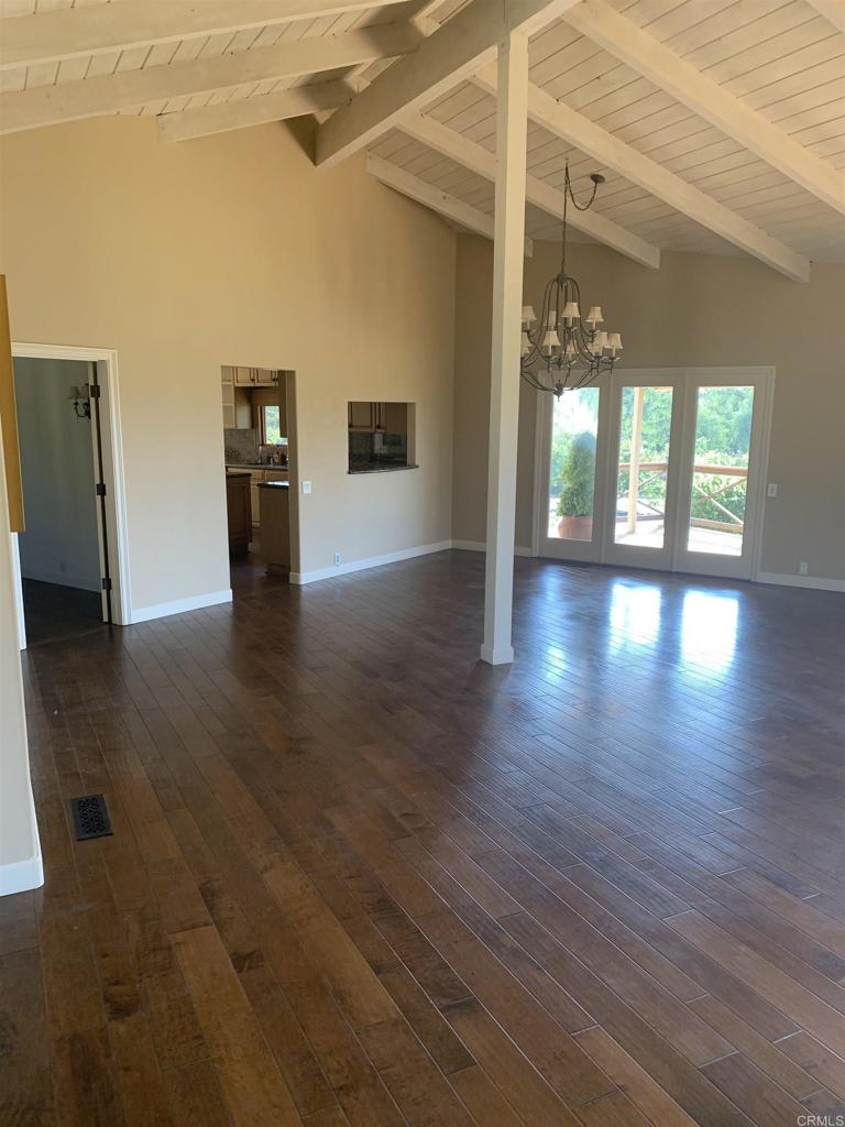 6858 Las Colinas Rancho Santa Fe, CA 92067 - Photo 15 of 23 an empty room with wooden floor and windows
