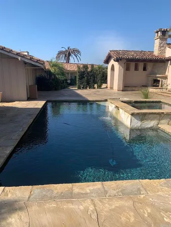a view of a swimming pool with an outdoor space and seating area