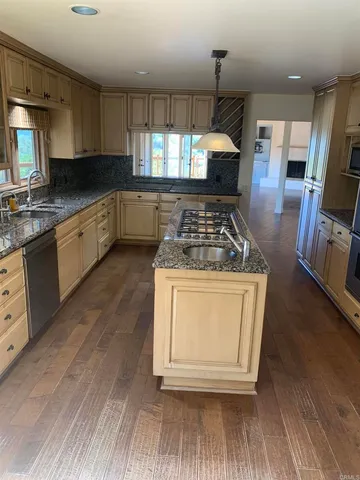 a kitchen with a stove a sink and a microwave