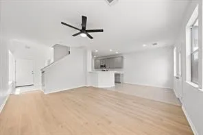 a view of a livingroom with a ceiling fan and window