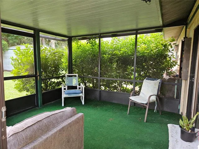 a view of hallway with furniture and a chandelier
