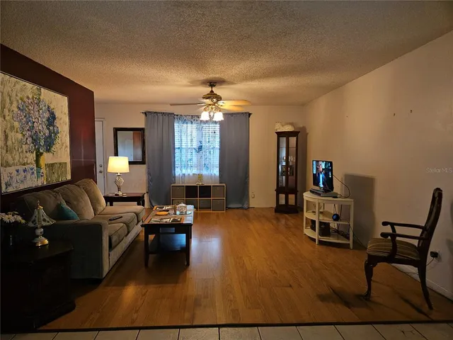 a view of a livingroom with furniture and a flat screen tv