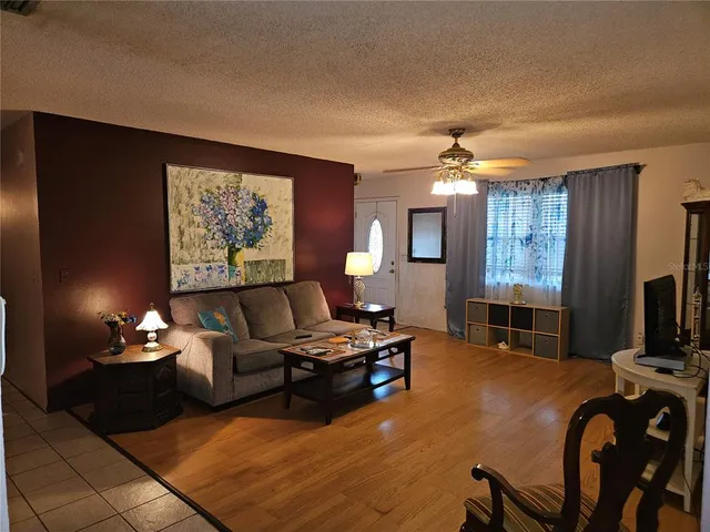 a kitchen with a dining table chairs and refrigerator