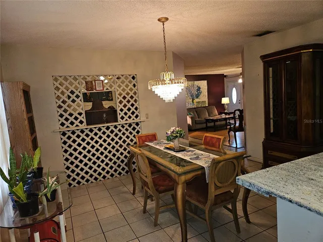a kitchen with a table chairs and a refrigerator