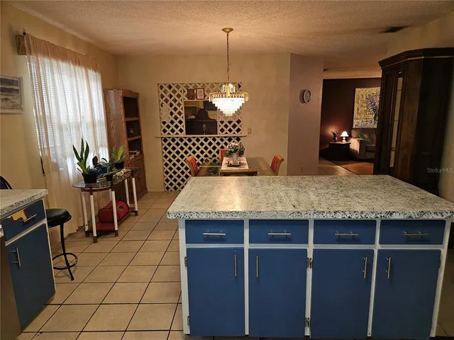 a kitchen with stainless steel appliances granite countertop a refrigerator a sink a stove a microwave and wooden cabinets