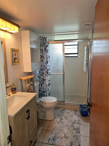 a bathroom with a sink toilet and mirror