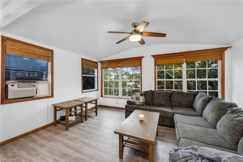 3261 Lakeview Drive Naples, FL 34112 - Photo 11 of 18 a living room with furniture and a large window