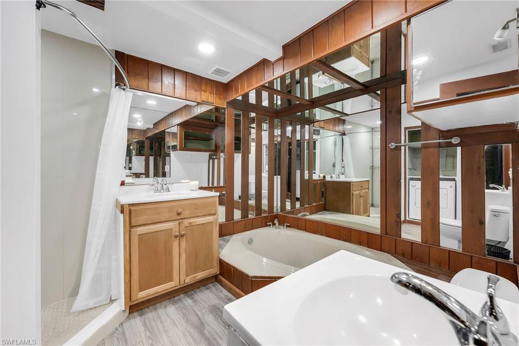 3261 Lakeview Drive Naples, FL 34112 - Photo 14 of 18 a spacious bathroom with a sink a mirror and shower
