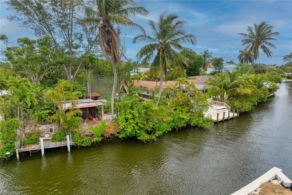3261 Lakeview Drive Naples, FL 34112 - Photo 18 of 18 a view of a garden with a table and chairs