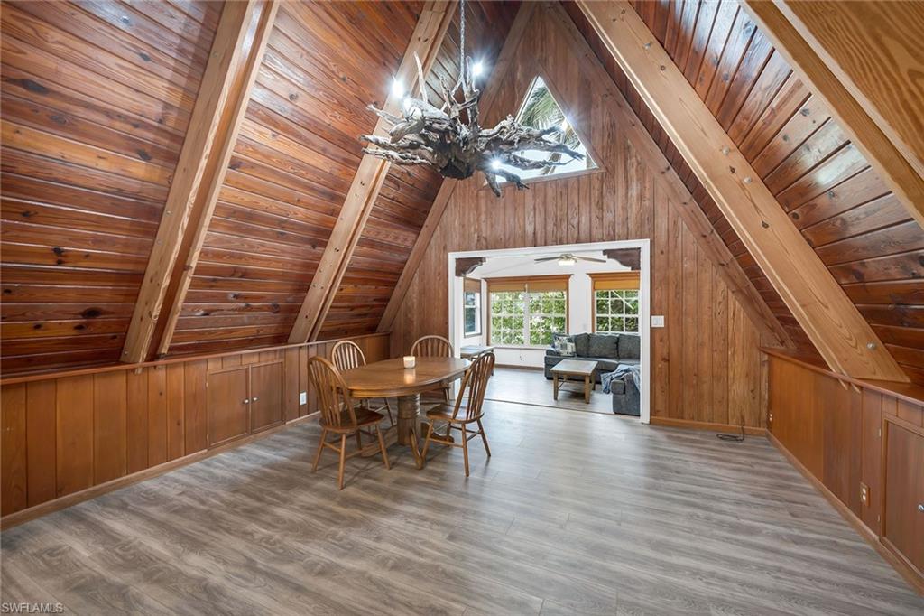 3261 Lakeview Drive Naples, FL 34112 - Photo 10 of 18 a view of a dining room with furniture window and wooden floor