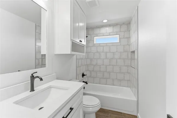a bathroom with a sink a toilet and bathtub