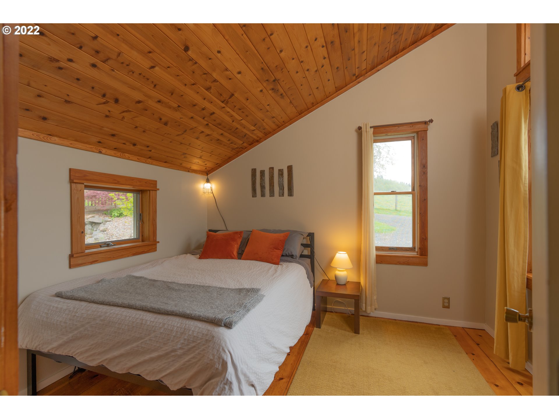 89907 Youngs River Road Astoria, OR 97103 - Photo 15 of 32 a bedroom with a bed and a window