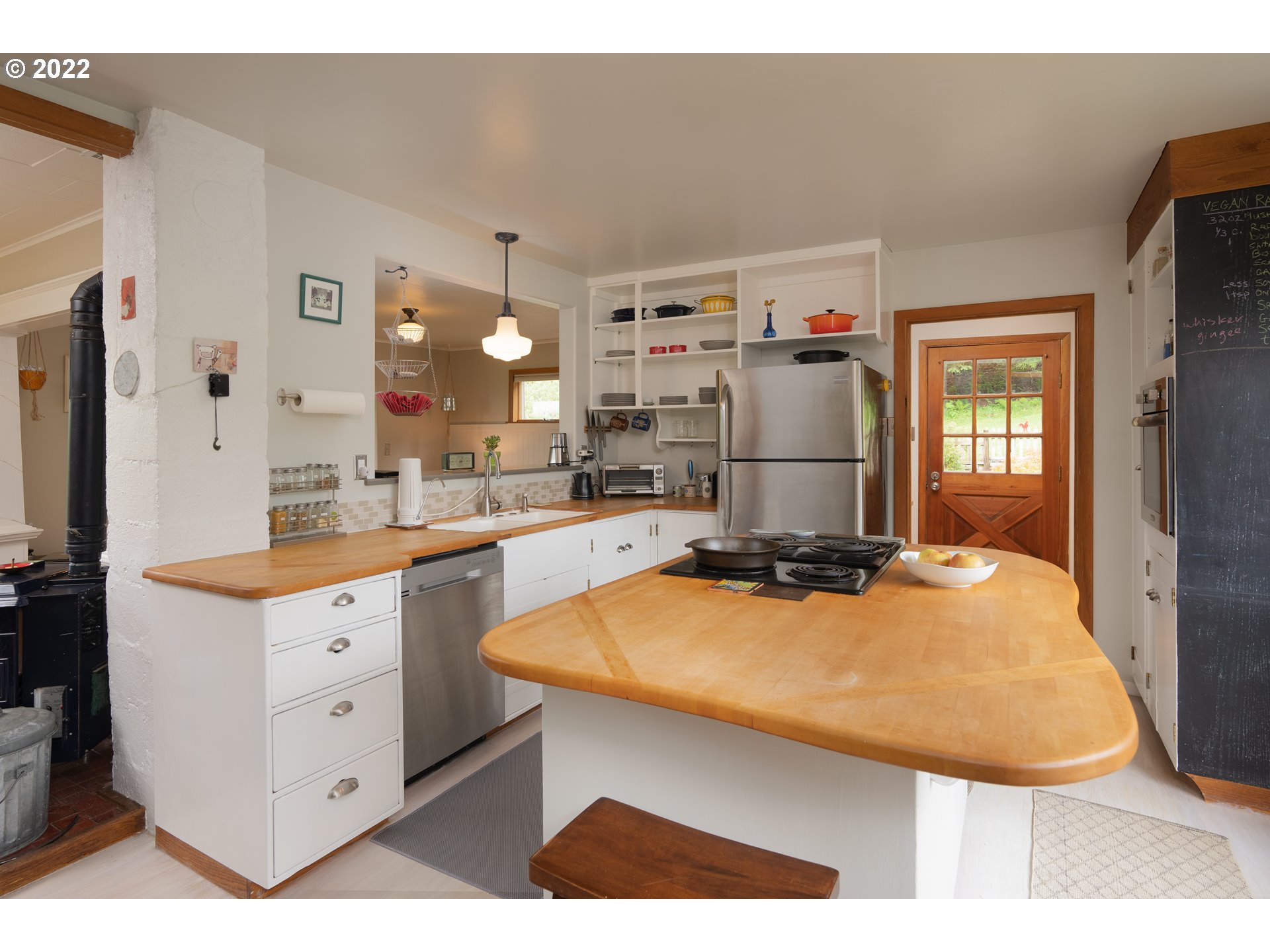 89907 Youngs River Road Astoria, OR 97103 - Photo 17 of 32 a kitchen with a sink a stove and cabinets