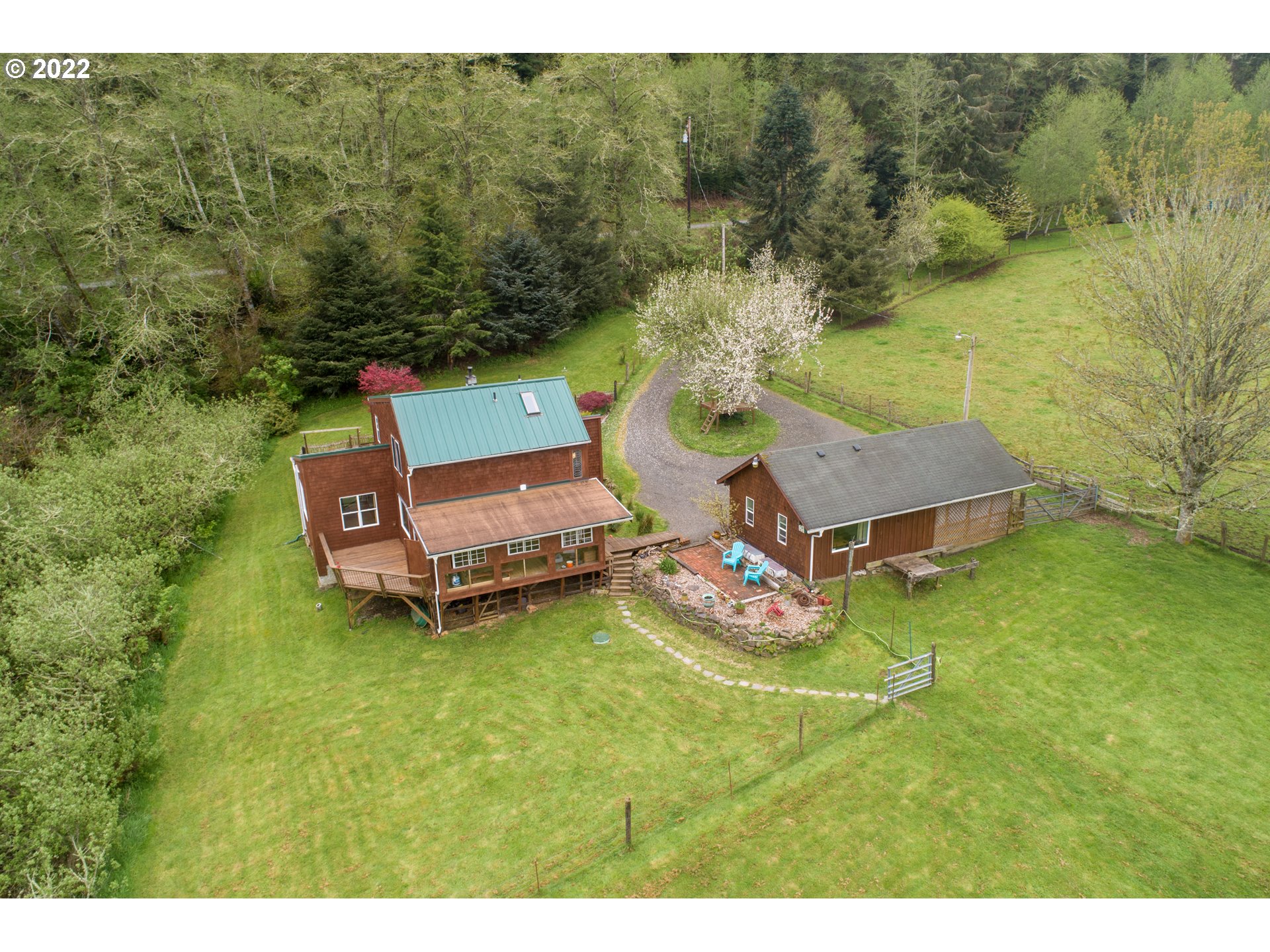 89907 Youngs River Road Astoria, OR 97103 - Photo 2 of 32 a backyard of a house with table and chairs