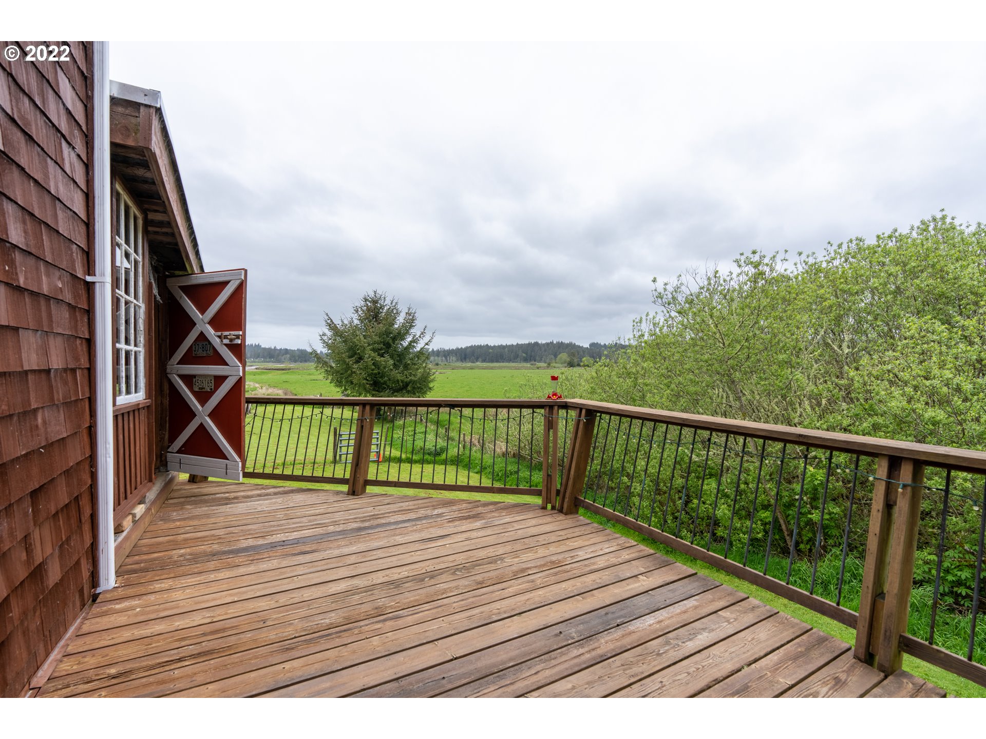 89907 Youngs River Road Astoria, OR 97103 - Photo 25 of 32 a view of balcony with wooden floor and fence
