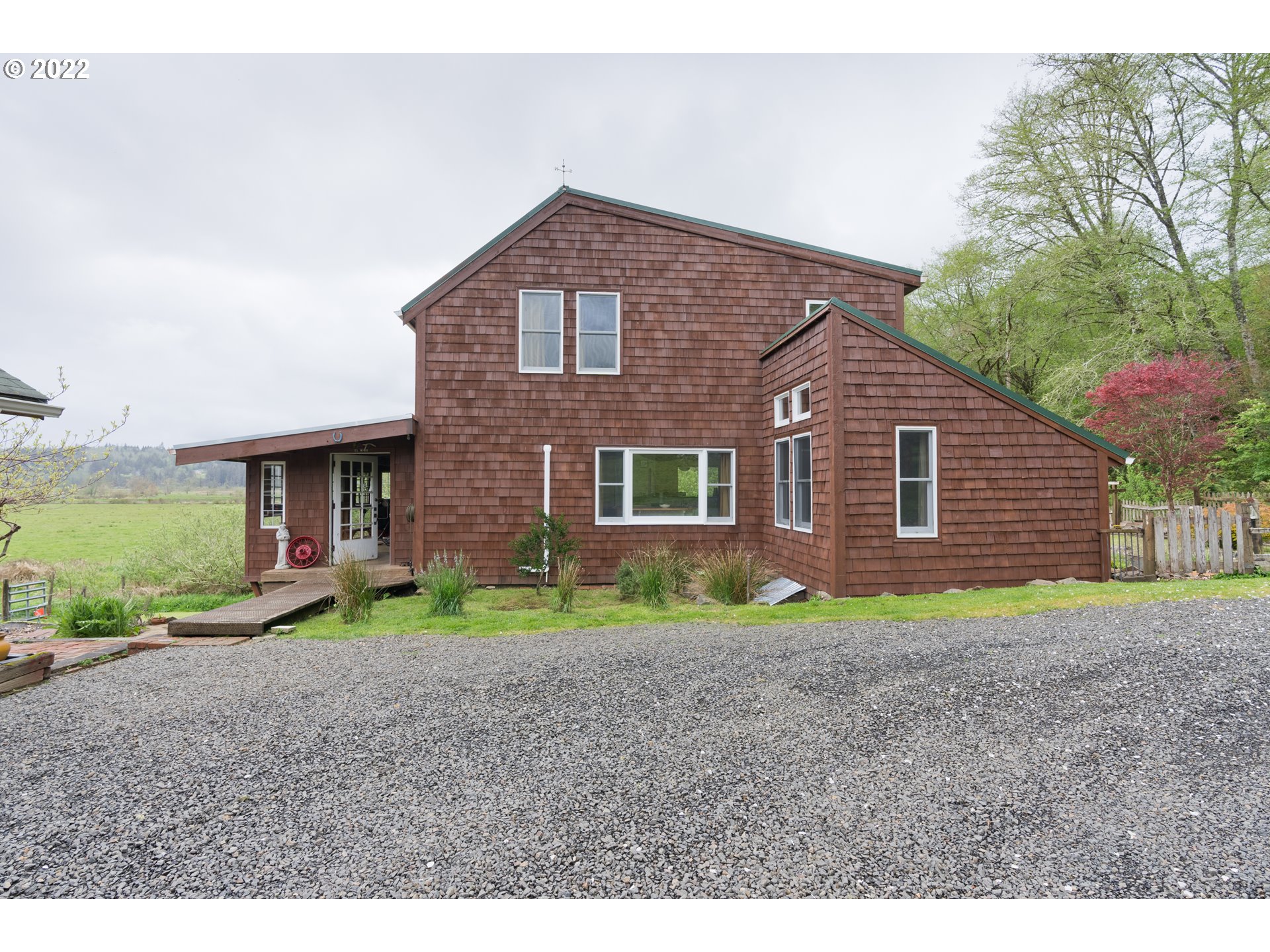 89907 Youngs River Road Astoria, OR 97103 - Photo 7 of 32 a front view of a house with a yard and garage