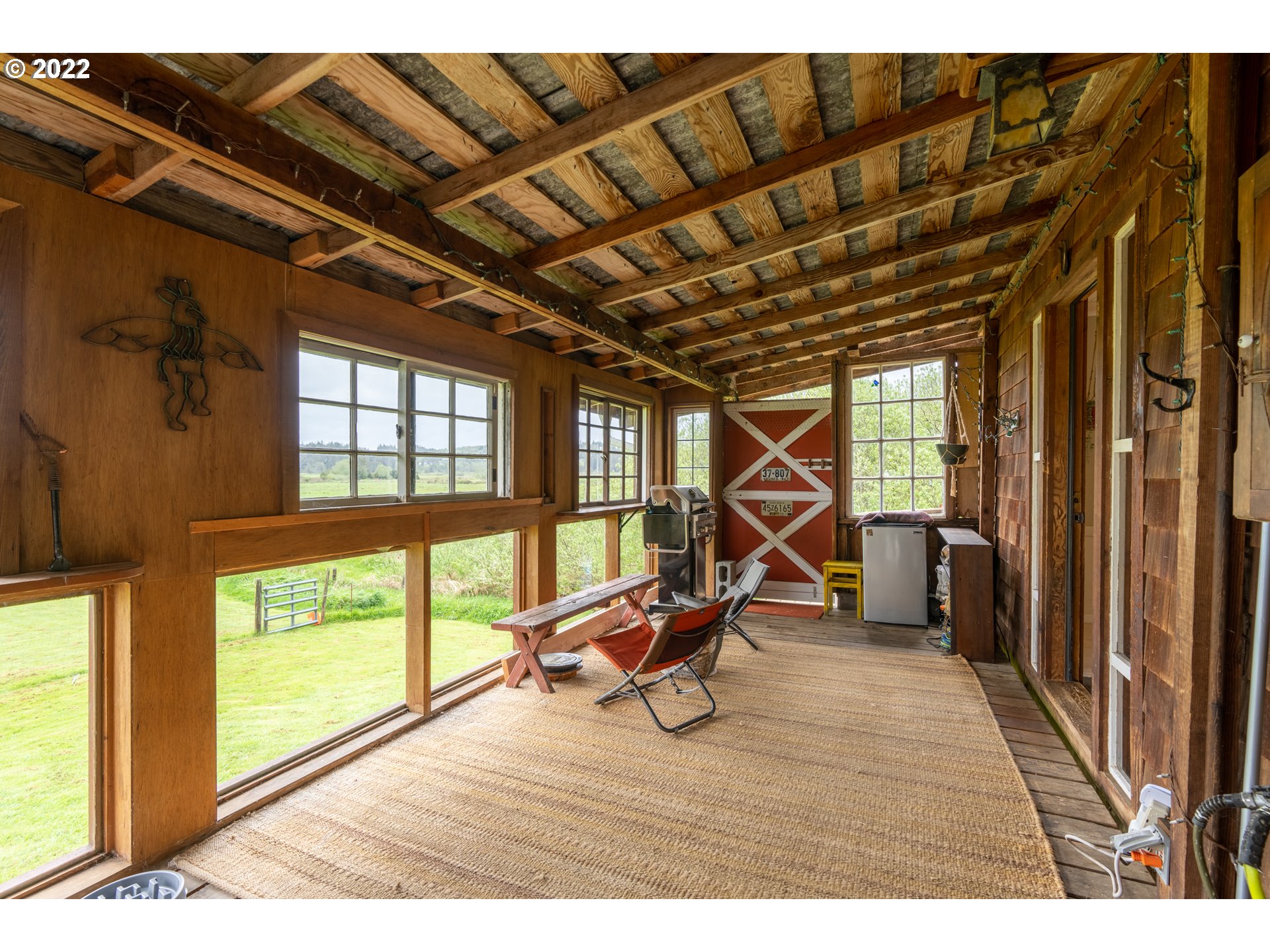 89907 Youngs River Road Astoria, OR 97103 - Photo 8 of 32 a view of a room with wooden floor and windows