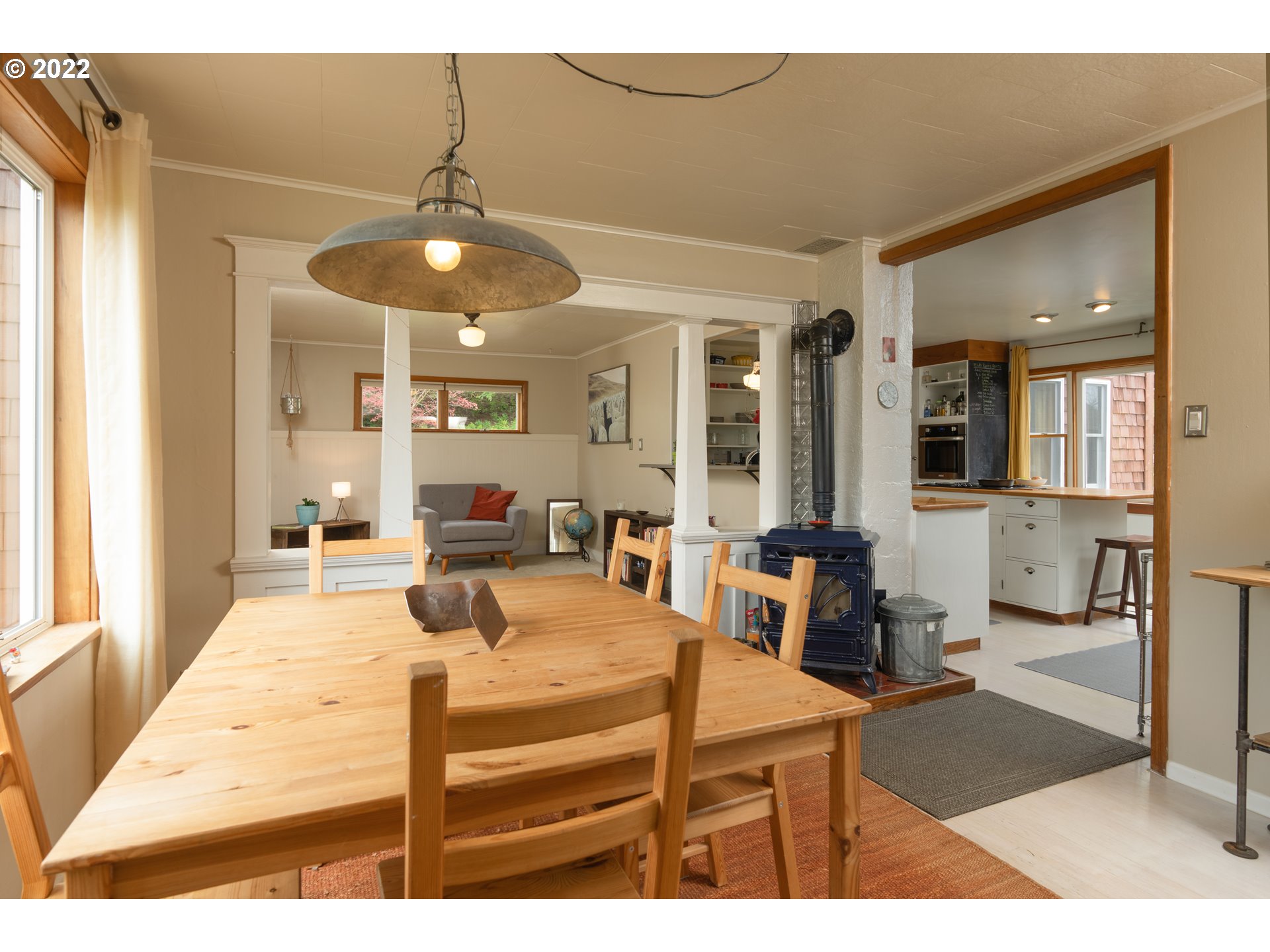 89907 Youngs River Road Astoria, OR 97103 - Photo 10 of 32 a living room with furniture a chandelier and a dining table
