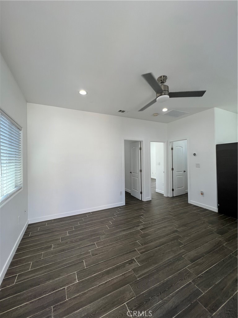 2357 Ellen Street Colton, CA 92324 - Photo 5 of 15 an empty room with wooden floor a ceiling fan and windows