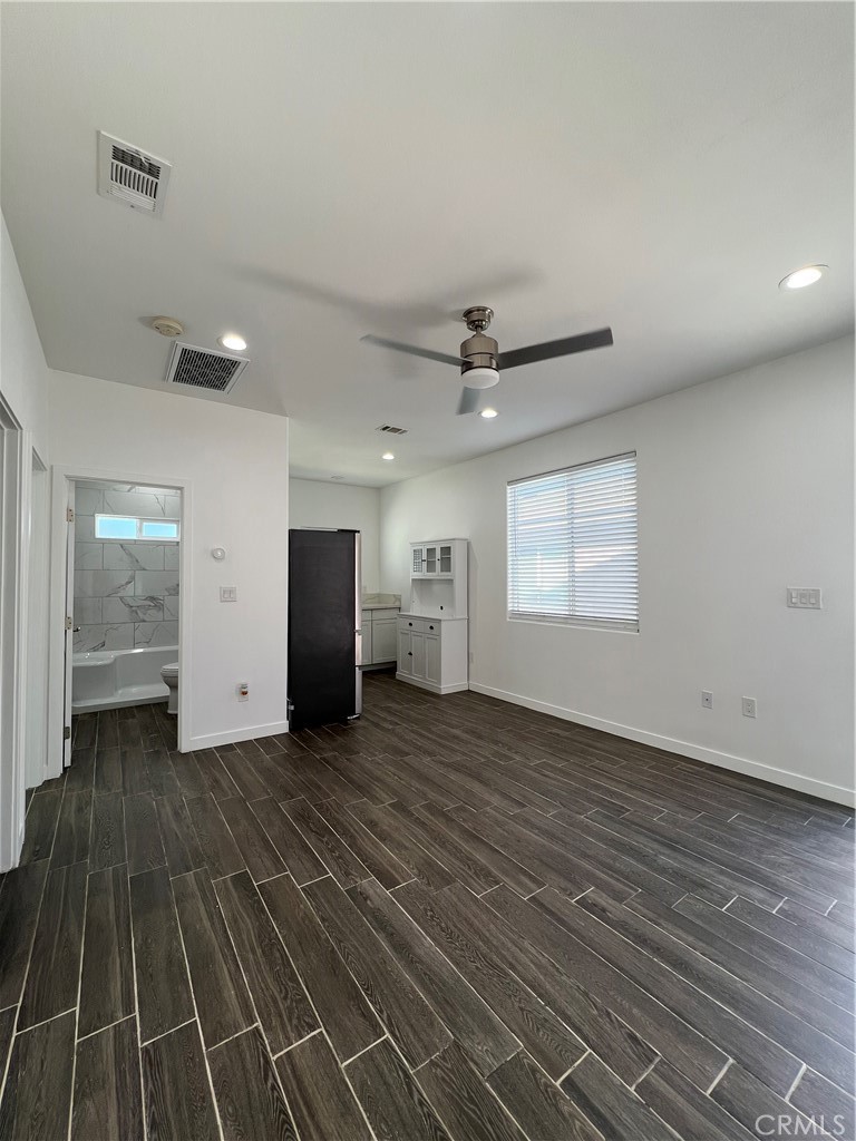 2357 Ellen Street Colton, CA 92324 - Photo 6 of 15 an empty room with wooden floor closet and windows