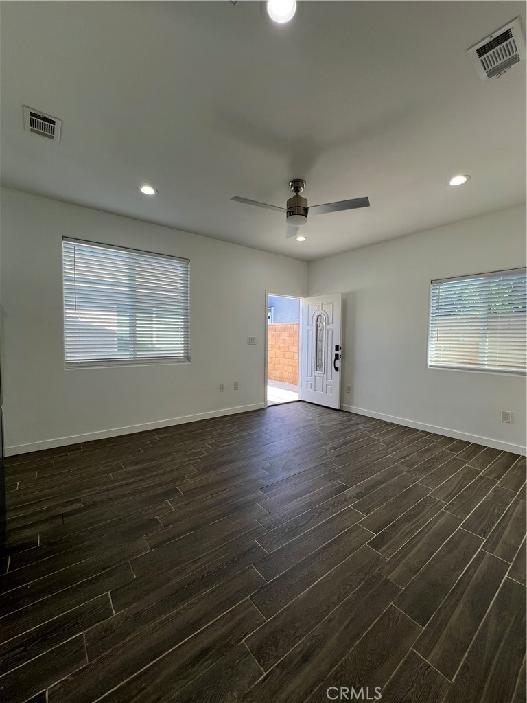 2357 Ellen Street Colton, CA 92324 - Photo 8 of 15 an empty room with wooden floor and windows